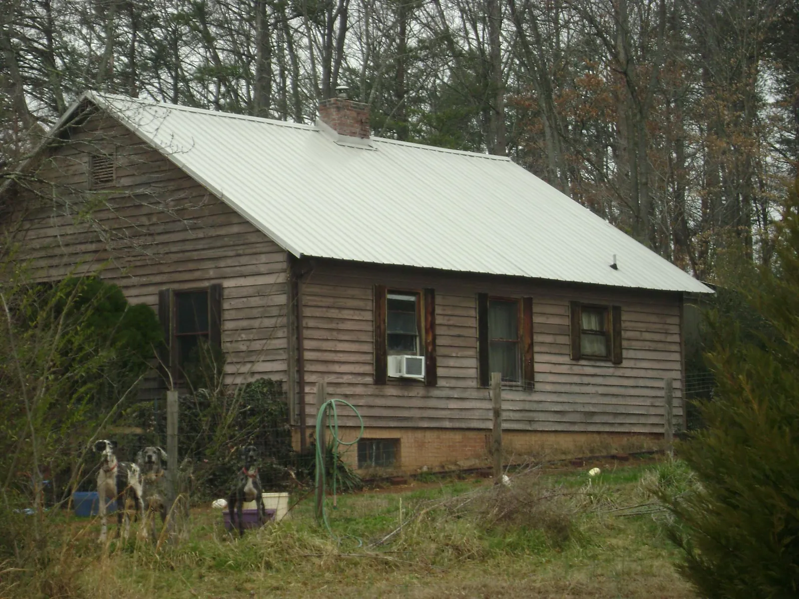 White metal roof on an old wood sided farmhouse, from a Metal Roof Installation job in Kyles Ford